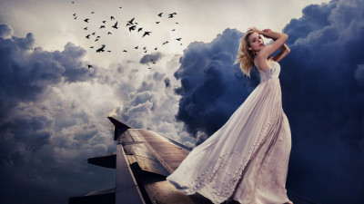 Beautiful girl on the airplane wing