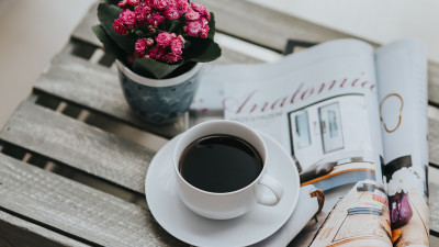 One coffee cup and one magazine