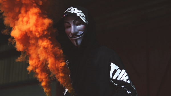 Anonymous mask and orange smoke